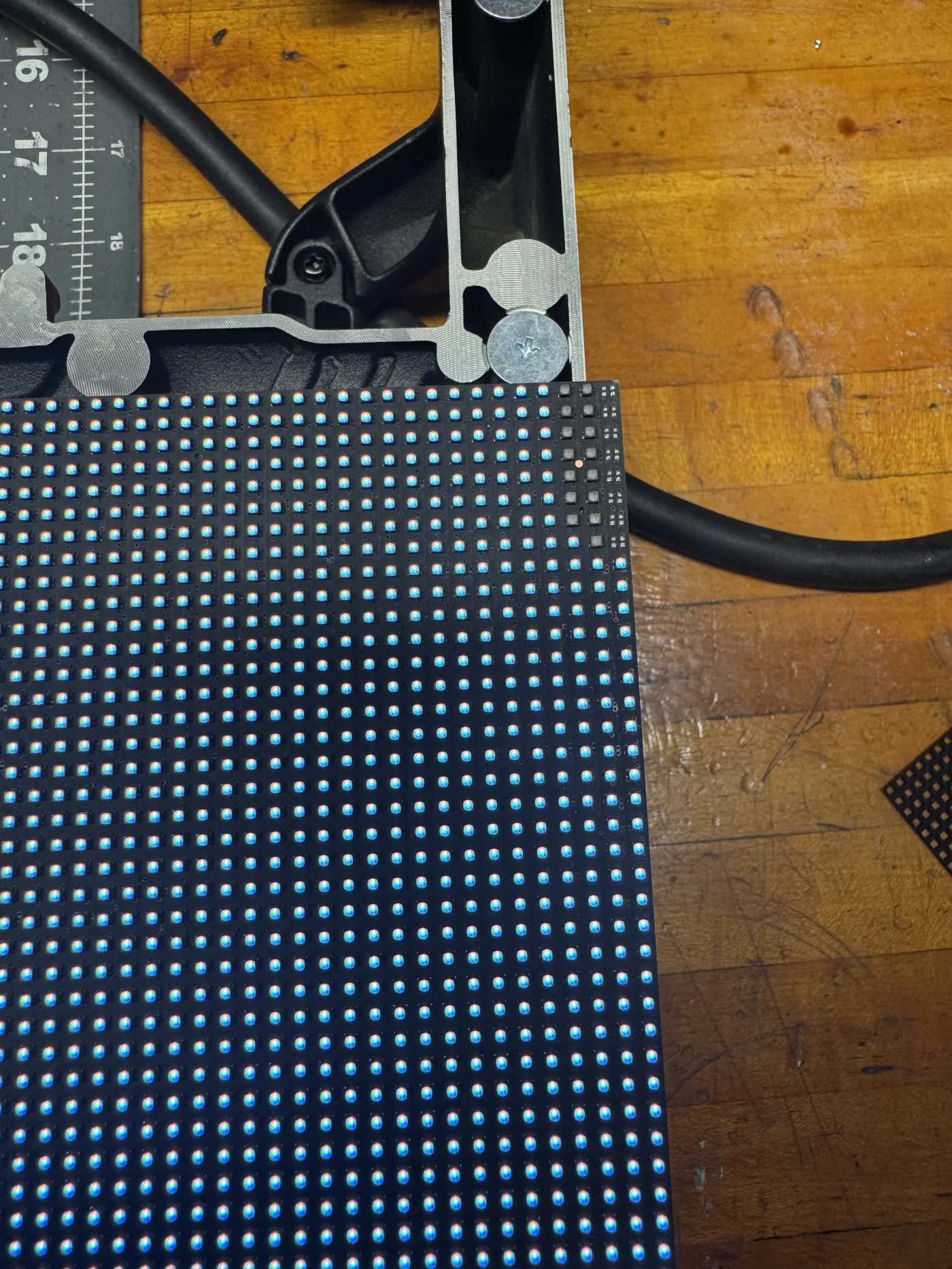 Real LED module being measured with a caliper during inspection